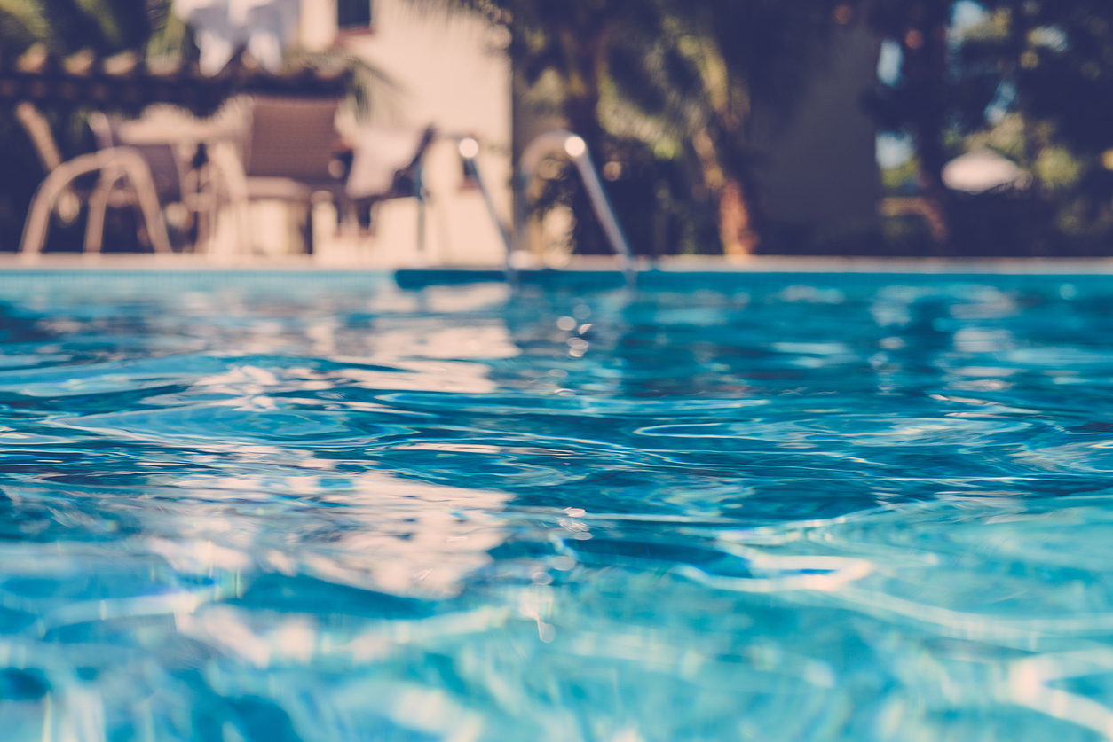 blurred surface view on blue swimming pool